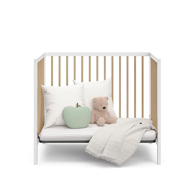 Graco Teddi 4-in-1 Convertible Mini Crib with Bonus Water-Resistant Mattress (White with Driftwood) – GREENGUARD Gold Certified, 2.75-Inch Mattress Included, Convenient Size, Easy 30-Minute Assembly