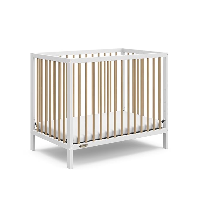Graco Teddi 4-in-1 Convertible Mini Crib with Bonus Water-Resistant Mattress (White with Driftwood) – GREENGUARD Gold Certified, 2.75-Inch Mattress Included, Convenient Size, Easy 30-Minute Assembly