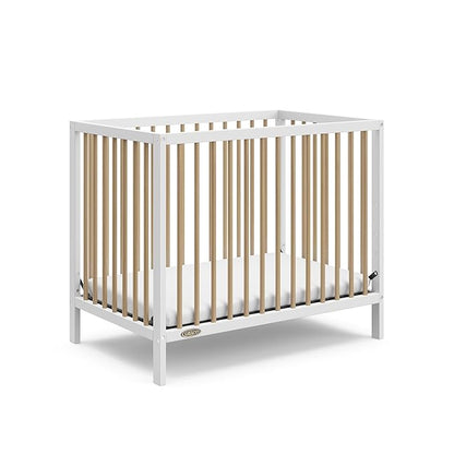 Graco Teddi 4-in-1 Convertible Mini Crib with Bonus Water-Resistant Mattress (White with Driftwood) – GREENGUARD Gold Certified, 2.75-Inch Mattress Included, Convenient Size, Easy 30-Minute Assembly